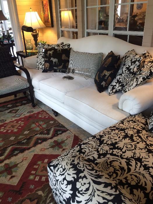 White 3 cushioned sofa; some of the many pillows