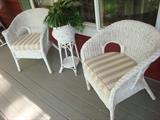 Pair of older wicker chairs and a plant stand