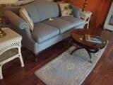 Another sofa and wicker tables, brass lamps and other items