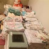 Table Full of Bed Linens and Towels