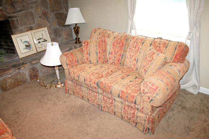 Upholstered loveseat and lamps