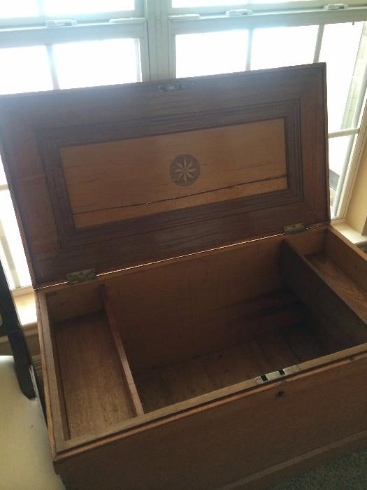Storage chest with inlaid wood and several compartments