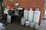 Microwave, rotisserie, propane tanks, boxes of canning jars