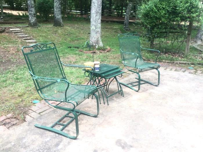 Side view of green rockers and nesting tables