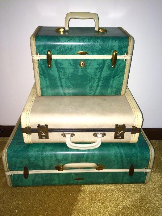 Emerald hardshell Samsonite train case and suitcase; various other vintage cases, like the one pictured here in the center, are in the sale