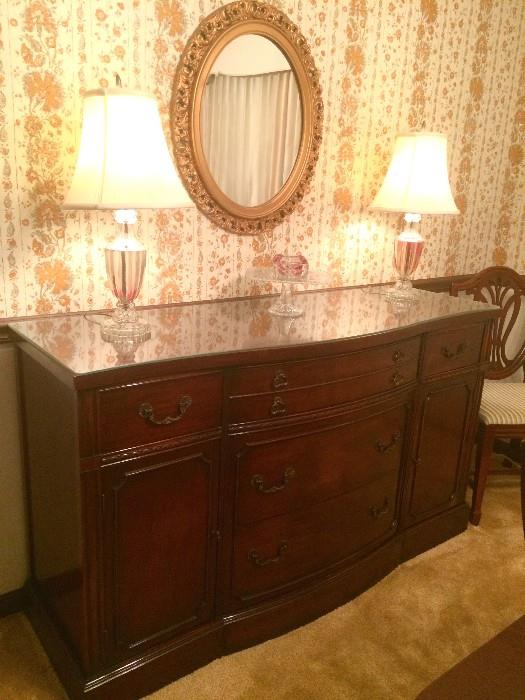 Duncan-Phyfe-style antique buffet with glass top; matching glass lamps with red accent