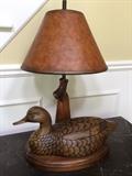Hand carved duck lamp with gun stock supporting the shade 