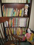 Tons of children's books and rocker w/hand caned seat, and one of two nice tall mahogany finish bookcases