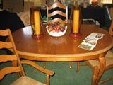 Oval pine dining table with leaf and four rush seat chairs