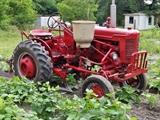 Farmall Garden Tractor – Runs Great! Includes 6 plow blades. 4 tine rake, chain driven fertilizer hopper with hose attachment, accessory bar for attachments, 6 extra attachment shanks, 2 discs hillers and middle buster, clamps, extra sweeps, extra hiller, 3 point hitch, belt drive attachment, tow bar