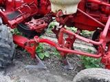 Farmall Garden Tractor – Runs Great! Includes 6 plow blades. 4 tine rake, chain driven fertilizer hopper with hose attachment, accessory bar for attachments, 6 extra attachment shanks, 2 discs hillers and middle buster, clamps, extra sweeps, extra hiller, 3 point hitch, belt drive attachment, tow bar