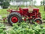 Farmall Garden Tractor – Runs Great! Includes 6 plow blades. 4 tine rake, chain driven fertilizer hopper with hose attachment, accessory bar for attachments, 6 extra attachment shanks, 2 discs hillers and middle buster, clamps, extra sweeps, extra hiller, 3 point hitch, belt drive attachment, tow bar