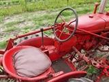 Farmall Garden Tractor – Runs Great! Includes 6 plow blades. 4 tine rake, chain driven fertilizer hopper with hose attachment, accessory bar for attachments, 6 extra attachment shanks, 2 discs hillers and middle buster, clamps, extra sweeps, extra hiller, 3 point hitch, belt drive attachment, tow bar