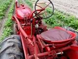 Farmall Garden Tractor – Runs Great! Includes 6 plow blades. 4 tine rake, chain driven fertilizer hopper with hose attachment, accessory bar for attachments, 6 extra attachment shanks, 2 discs hillers and middle buster, clamps, extra sweeps, extra hiller, 3 point hitch, belt drive attachment, tow bar