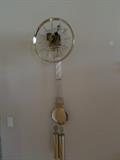 Round contemporary Howard Miller Solid Brass Wall Clock with Penduleum