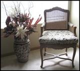 caned back upholstered side chair and Italian vase with dried floral arrangement