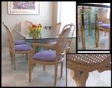 custom made contemporary metal based glass top dining table with six carved and caned chairs