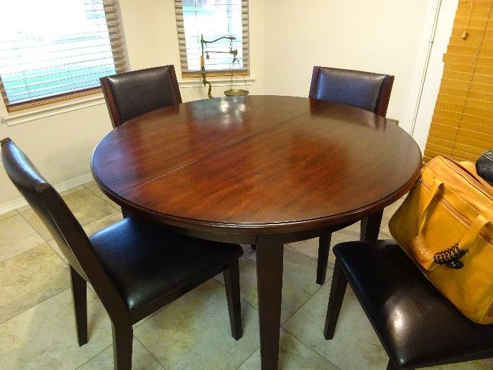 48" round table with a leaf underneath that is 15" so total is 63" long with leaf   and 4 chairs