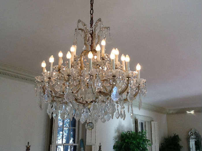 Pair of Rock Crystal Quartz Maria Theresa-style thirty-light Chandeliers - 18th/19th century - suspended crystal bead garlands and French-cut leaf pendants aboe a central faceted crystal sphere - now electrified.