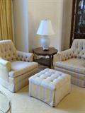 Matching upholstered chairs and ottoman, round side table and lamp