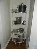 Nice baker's rack with various cookware items. 
