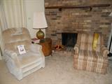 Close up of lift chair with instruction book, end table, lamp & matching chair to sofa & loveseat. 