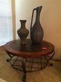 Large round contemporary coffee table with faux slate top with rust wood accents