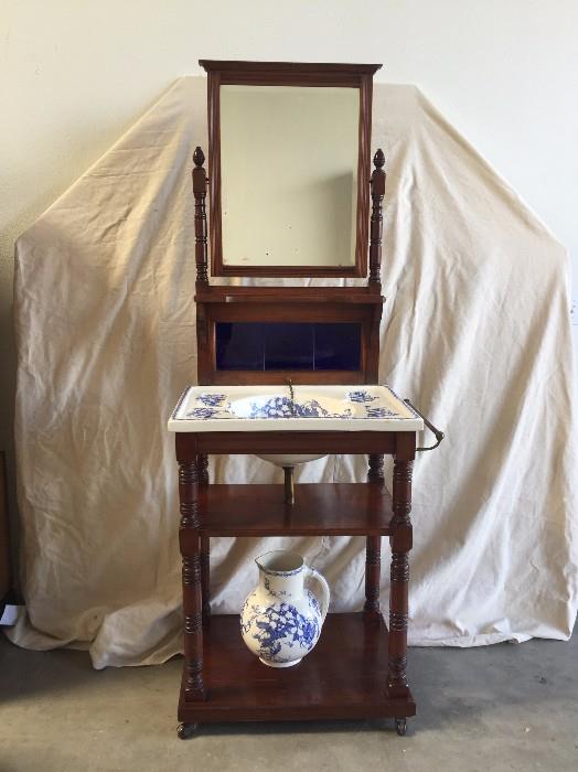 Circa 1850s Mahogany Dry Sink Stand, China Sink and Pitcher. All originial pieces. Mirror has some aging. bottom shelf has a crack and pitcher has been repaired. Sink and overall stand in very good antique condition. Bottom of sink and pitcher have the Keele Crest and Cauldon England mark.