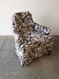 Club chair upholstered in a whimsical toile fabric, with tufting and Asian-motif toile upholstery.