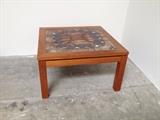 Solid teak table with textured clay tile top. Colors of brown, cream, rust and blue come together to really make this table a great conversation piece and landing zone. Ox Art 1977 maker's mark.