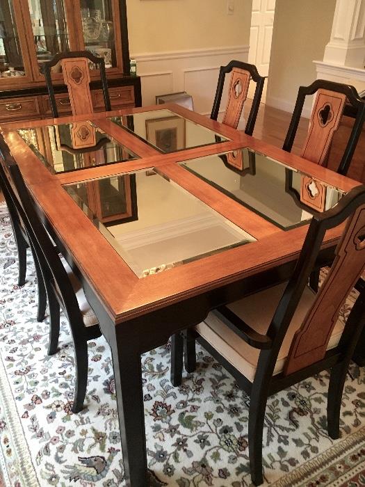 Thomasville dining room set is spectacular. Mirrored inserts accent the top of this table. There is an extension and pads to accompany it. There's not a mark on the stable. The chairs are also in excellent condition.