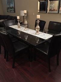 Beautiful 6.5ft X 3.5ft glass dining room table with black base and 6 chairs. Don't miss this great deal!