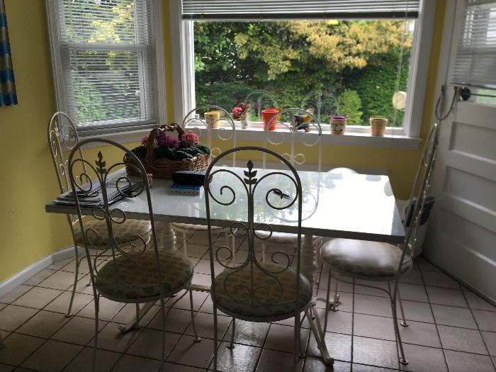 White glass top table with 6 iron chairs