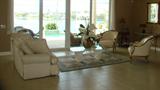 Carved wooden framed chairs are upholstered in buttery leather!