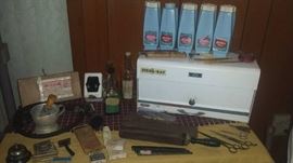 Vintage barber shop items including scissors, razors, combs, bell, Jeris tonic & talc, Sur-Lay hair dressing, Steril-Ray, Sanek tissue holder, & more.  