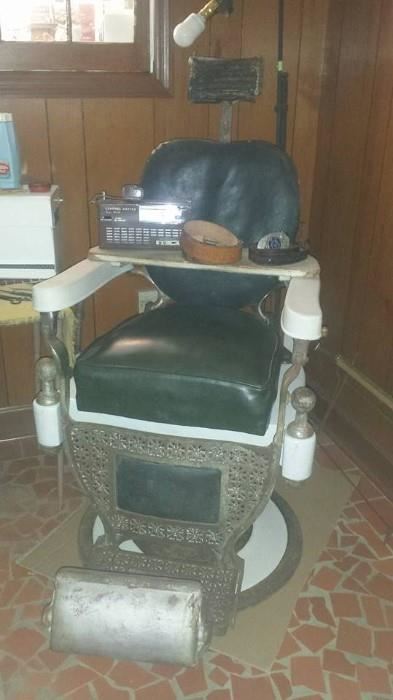 Original barber chair from the Owen barber shop marked Theo A Koch. 