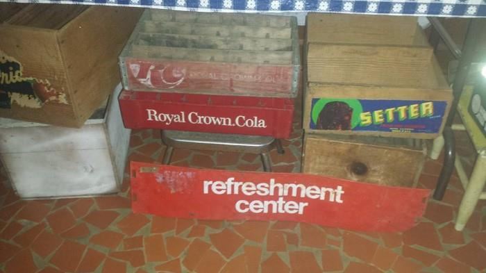 Crates including Royal Crown Cola (wooden & plastic), Refreshment Center metal sign (Coca Cola), & step stool. 