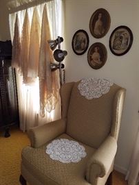 Parlor chair, oval prints, crocheted doilies & tablecloths. 