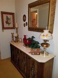 Prints, red glass, table lamp with hurricane, mirror, & marble top sofa table/cabinet. 