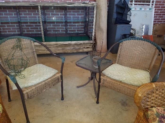 Pair of wicker chairs, wrought iron hanging basket, outdoor table, metal filing cabinets, vintage baby bed, area rug, & another pic of the display cabinet. 