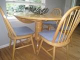 Drop leaf pedestal table with four chairs. High quality!