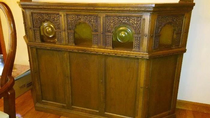 Carved Oak Bar. Moveable. Lighted Cabinet for hooch and barware storage.