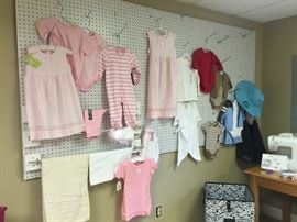 Selection of children's clothes and accessories from homeowner's custom sewing and monograming business