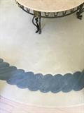Large round white rug with dusty blue beaded edge