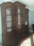 Mahogany breakfront with domed ends. 96" wide. Back panels custom covered with smoky grey satin.