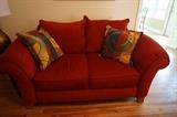 Red sofa with decorative pillows. 