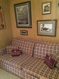 Framed duck prints; plaid sofa