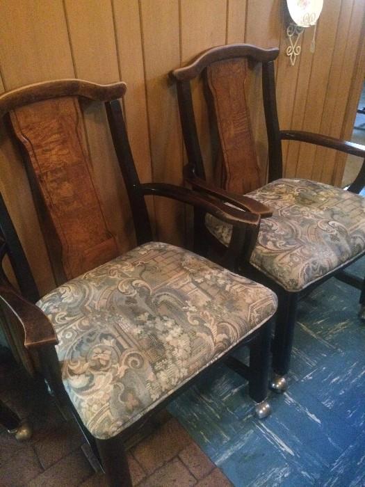 Two of four matching chairs with arms and rollers