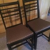 Two of four matching black chairs