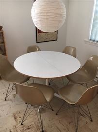Dining table: extension form with one leaf plywood with laminate top and metal, pedestal base; manufacturer Herman Miller, designed by George Nelson, dsigned in 1950s, made in 1960s.